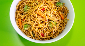 A large white bowl filled with Noodles and Peanut Sauce