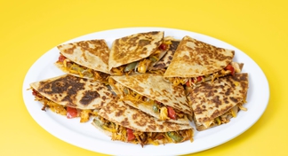 A white plate filled with Chicken Quesadillas