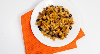 A white bowl filled with Chili Macaroni Skillet on an orange napkin