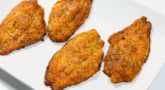 A white platter filled with Parmesan Crusted Catfish